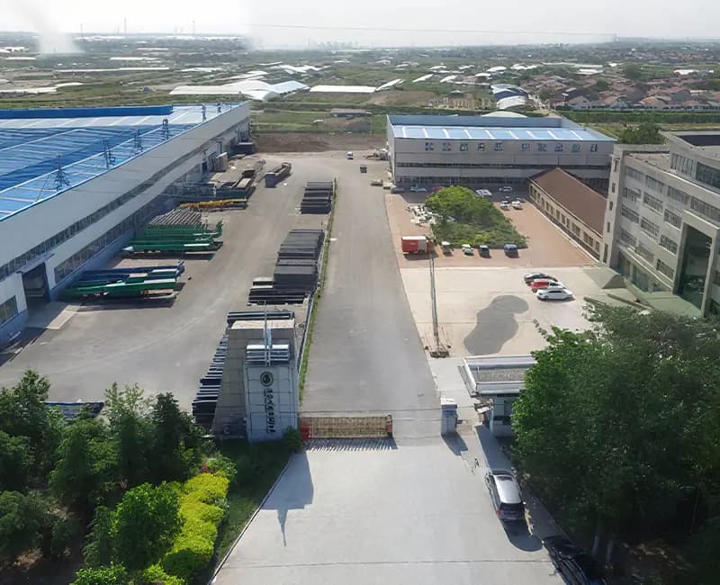 Aerial view of the Bailing Wooden factory campus with production halls and the timber storage yard
